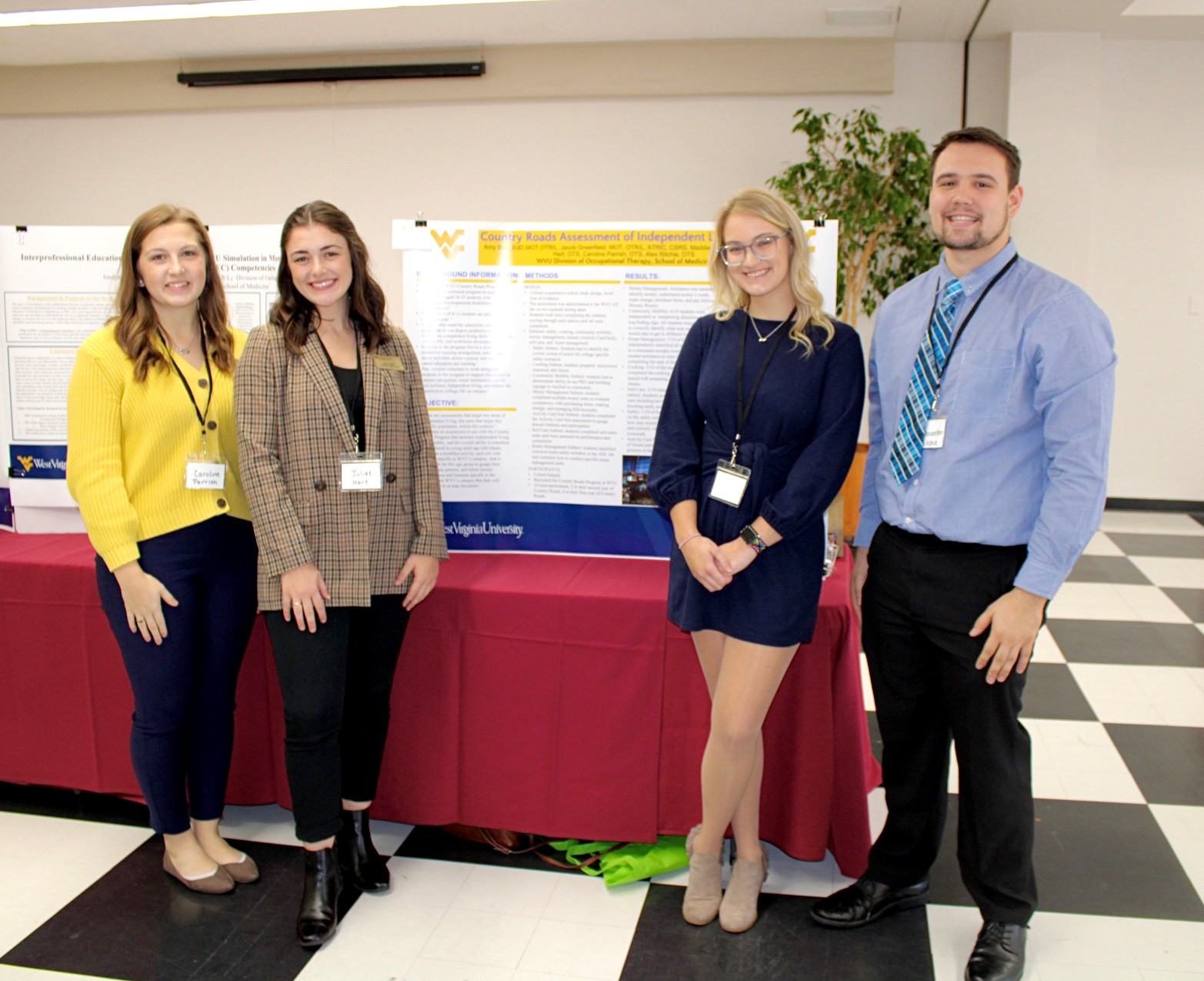 Students standing next to their poster