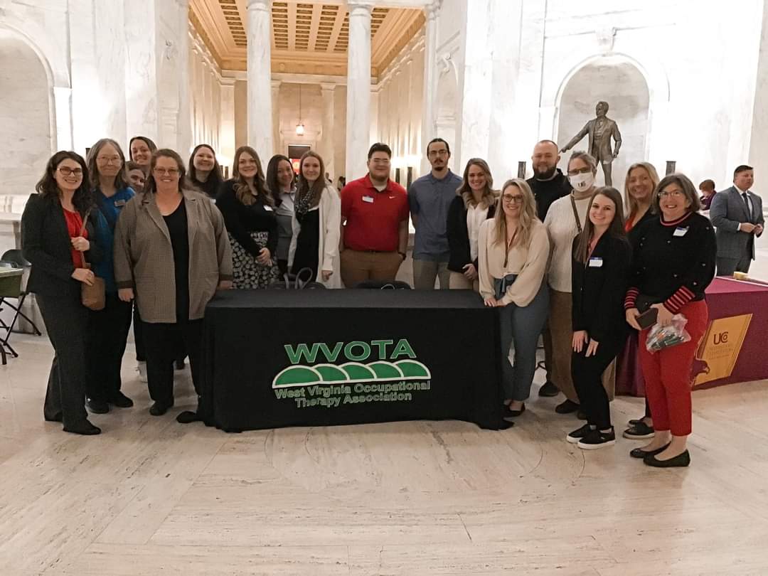 UC students gathered around a WVOTA Table